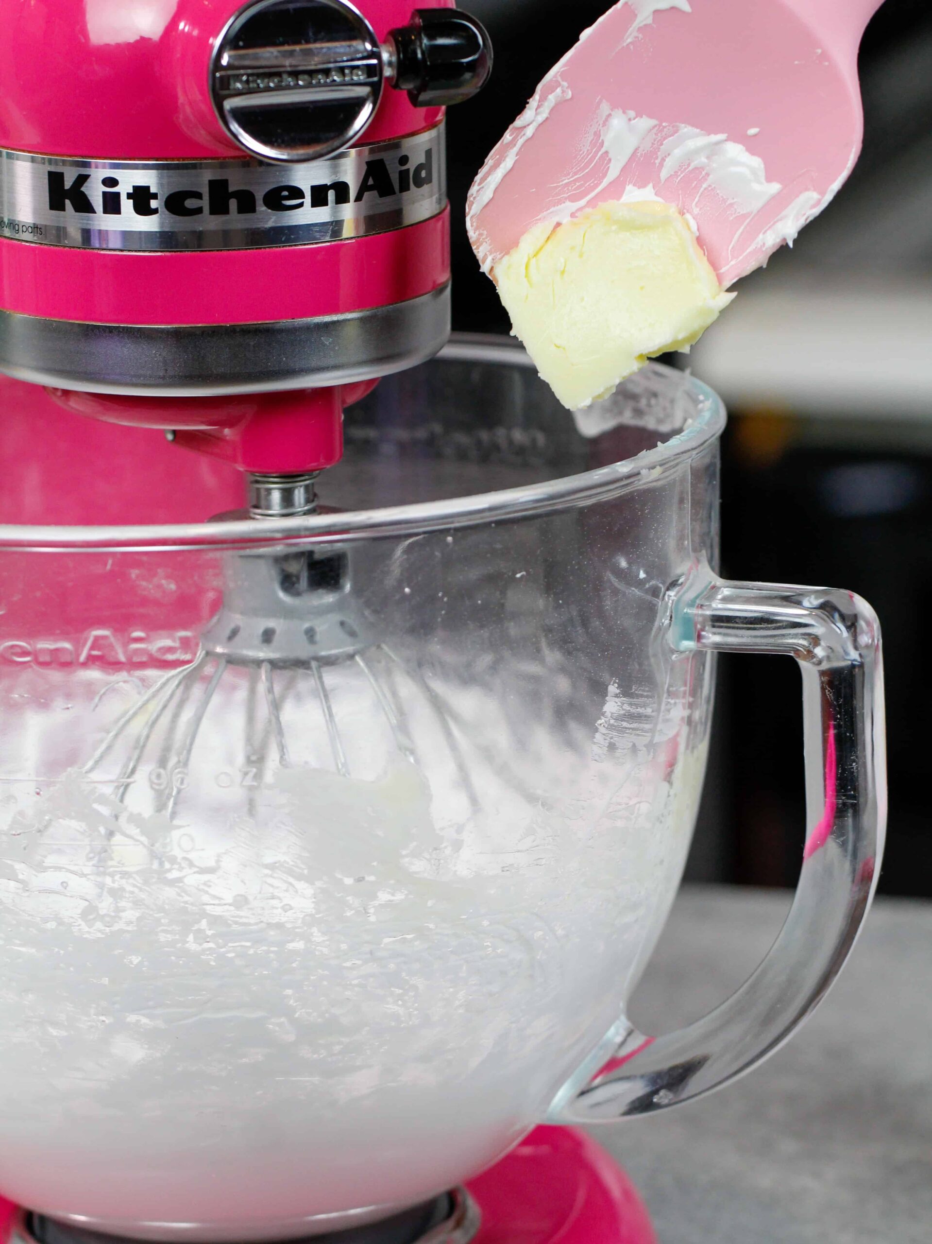 image of butter being slowly added into Italian meringue buttercream