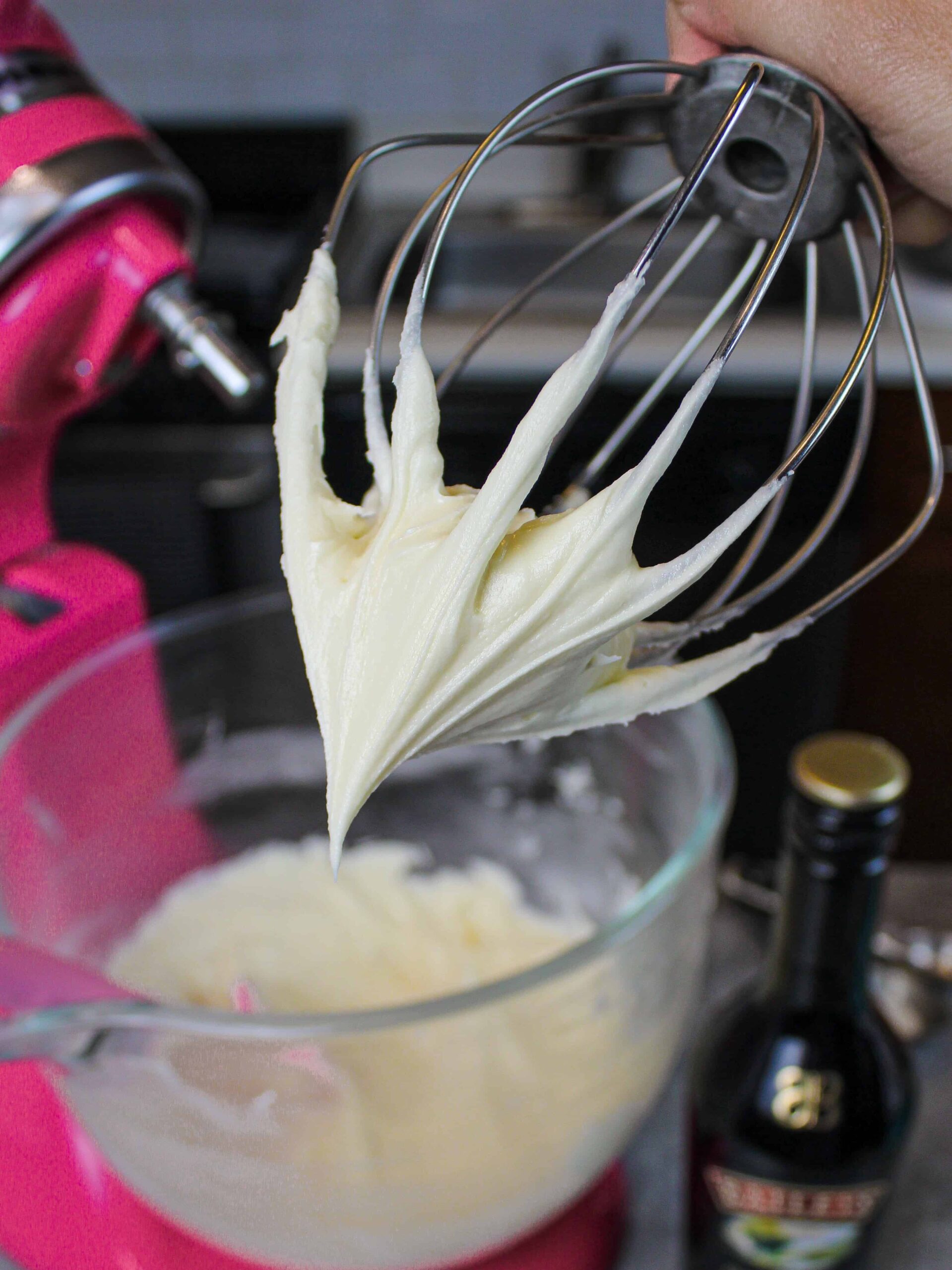 image of baileys frosting on a whisk attachment to show how smooth it is