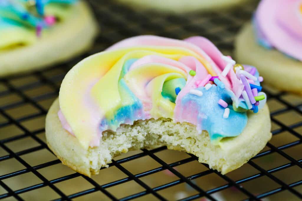 image of a buttercream cookie that's been bitten into to show it's soft, fluffy texture