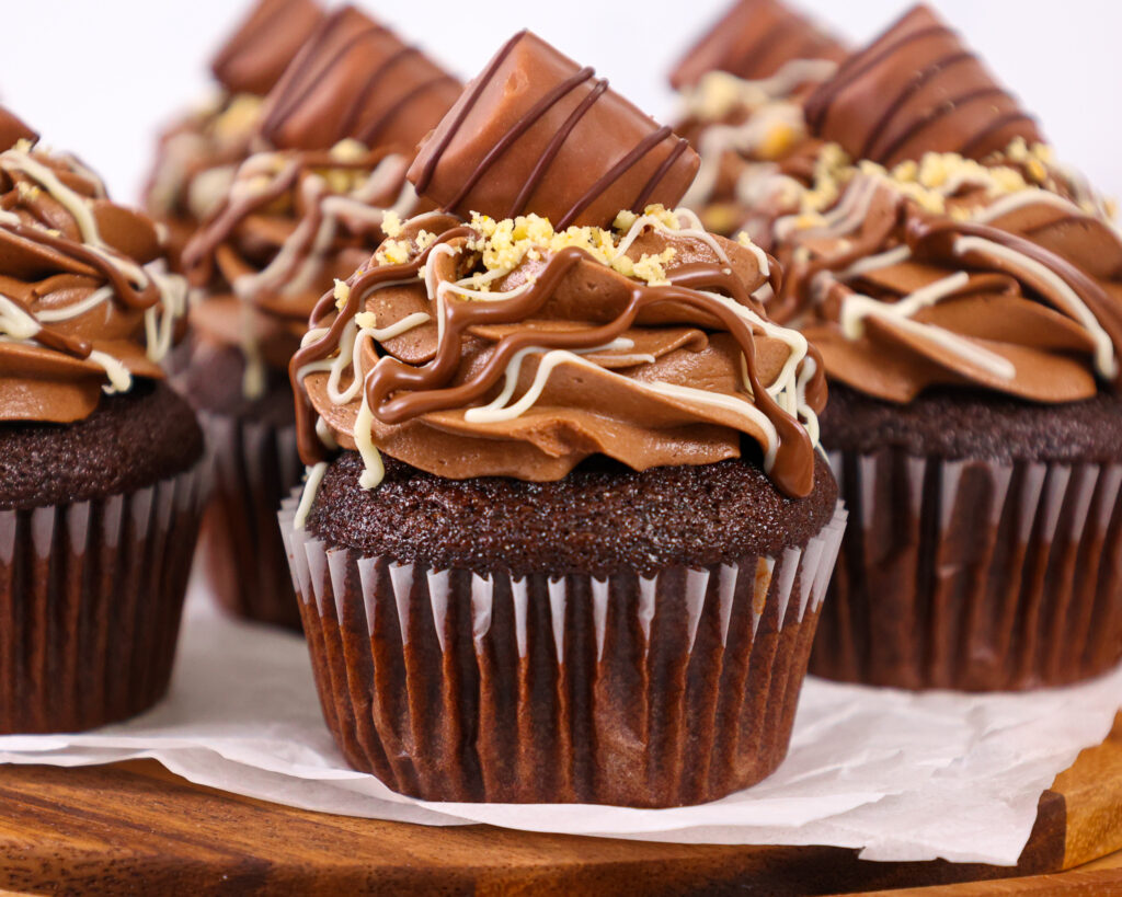 image of a kinder bueno cupcake that's been filled with hazelnut mousse and frosted with hazelnut chocolate buttercream frosting