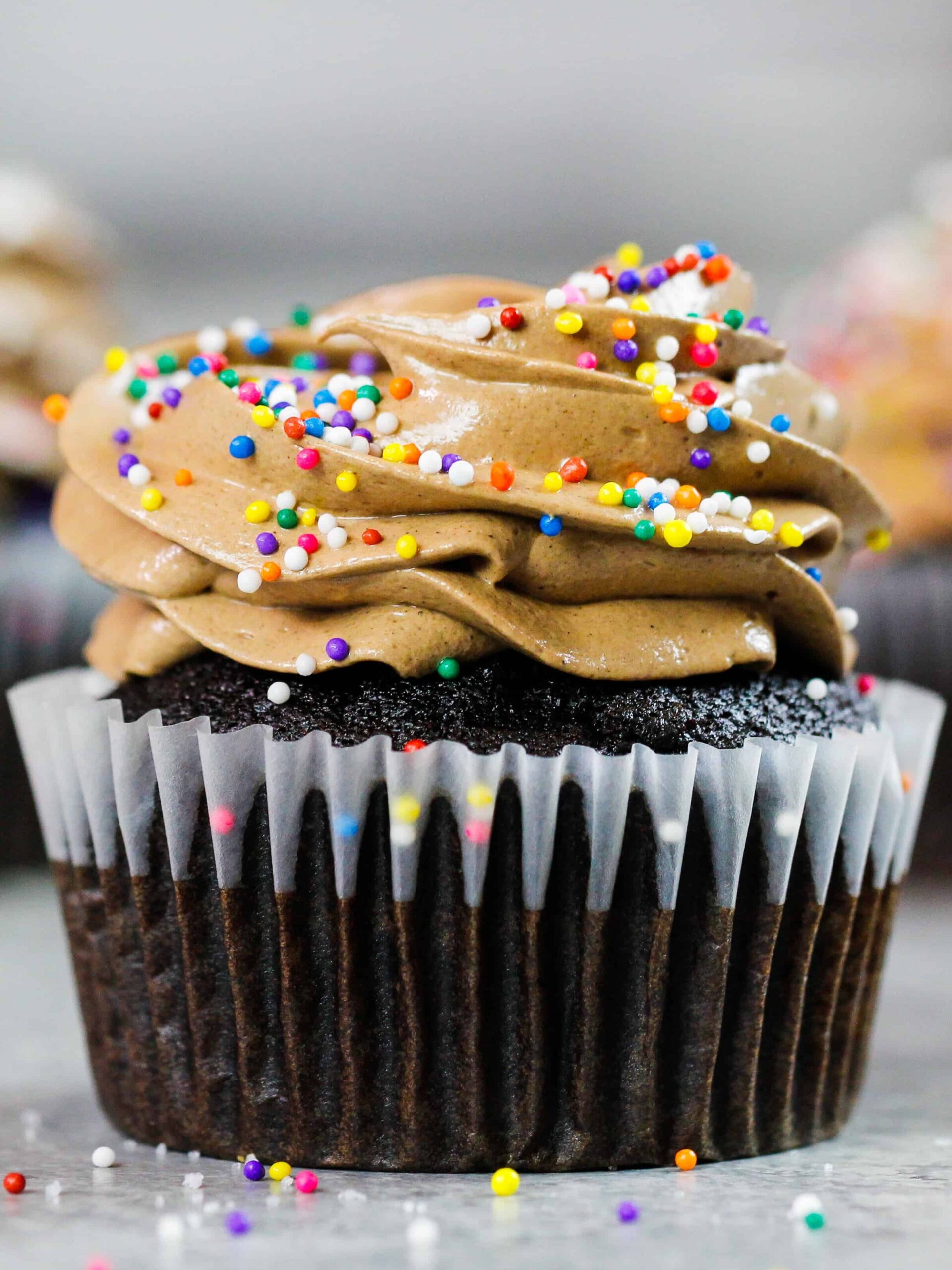 image of chocolate italian meringue buttercream frosting on top of cupcakes
