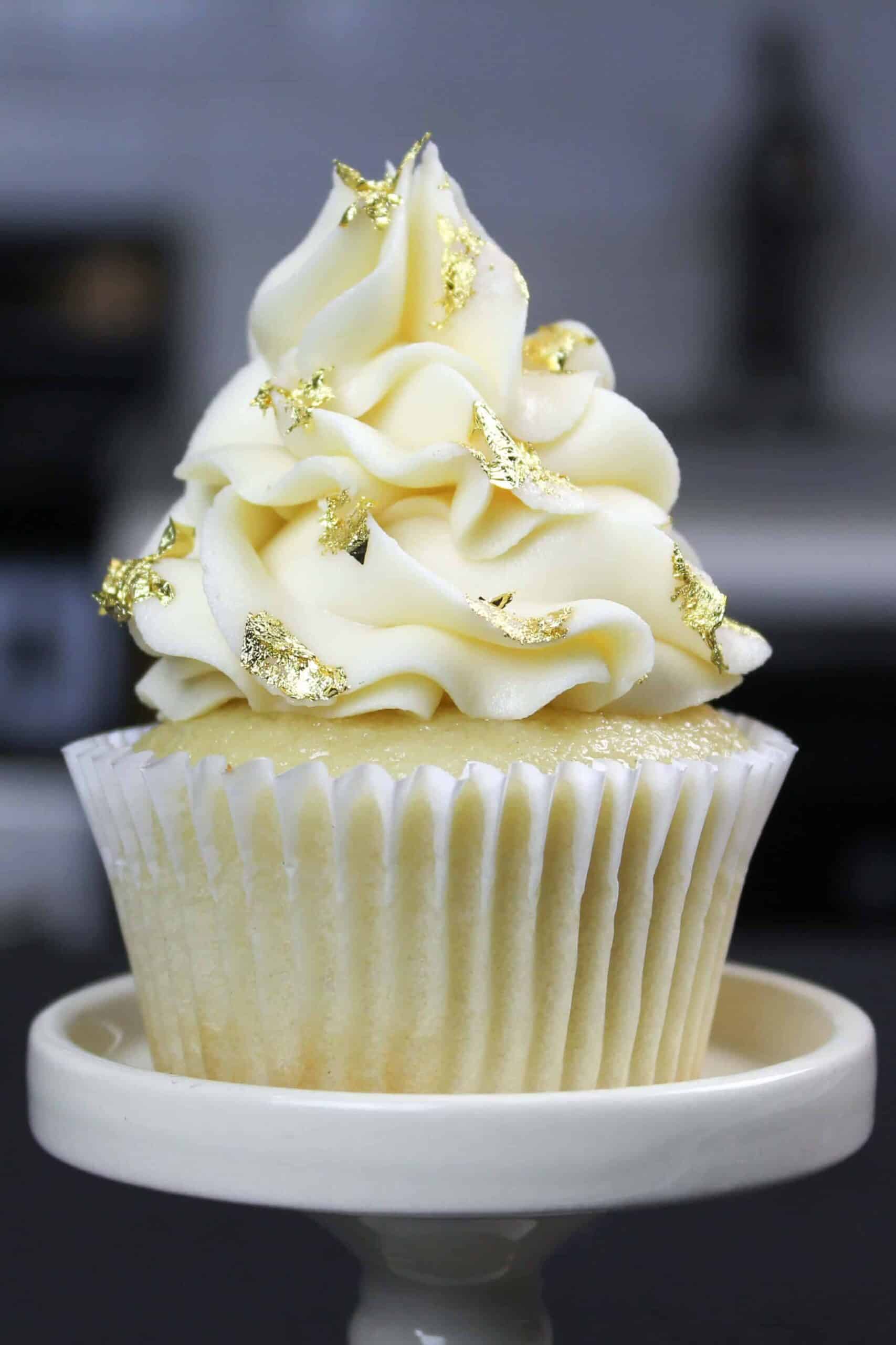 image of moist vanilla cupcake made with oil decorated with edible gold leaf