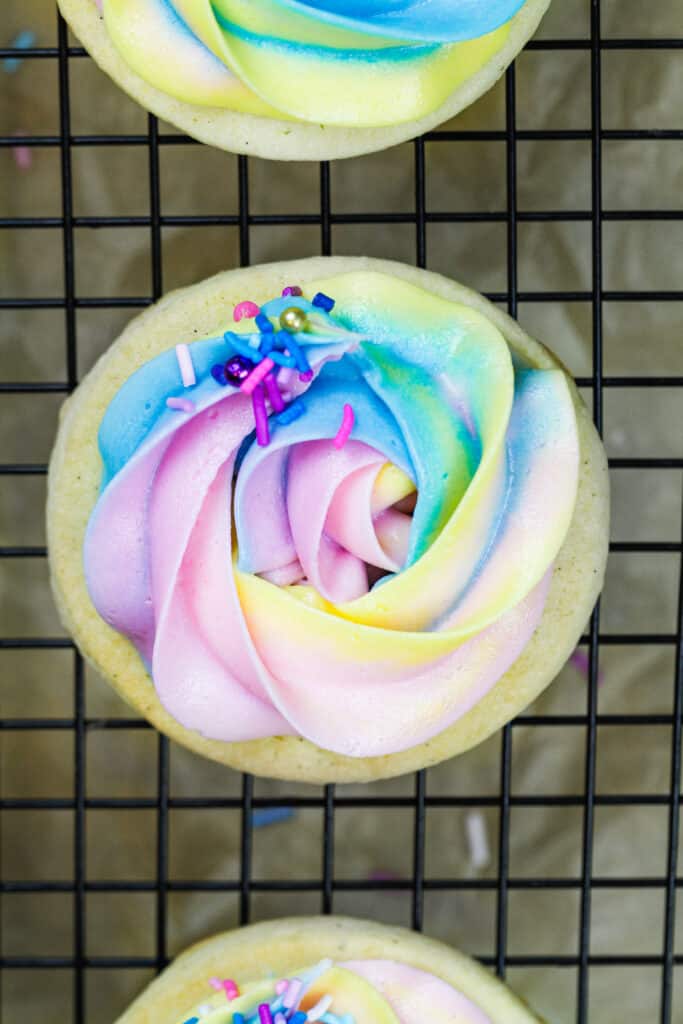 image of a cream cheese cookie that's been decorated with a pretty swirl of delicious buttercream frosting 
