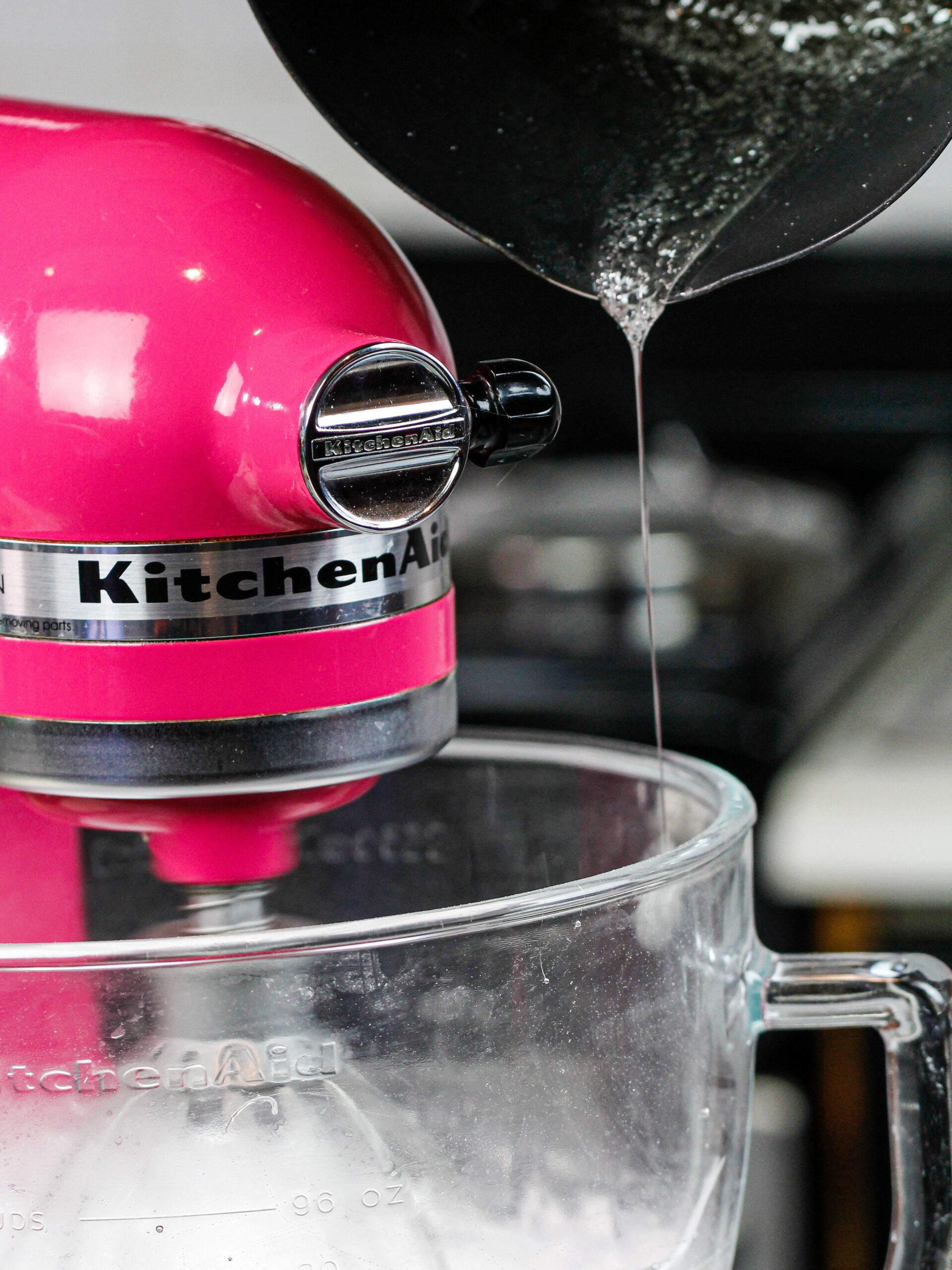 image of sugar syrup being poured into egg whites to make meringue for chocolate italian meringue buttercream